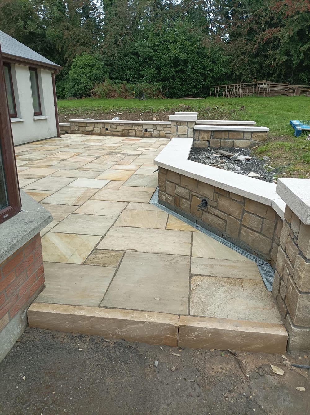 sandstone patio with stone wall