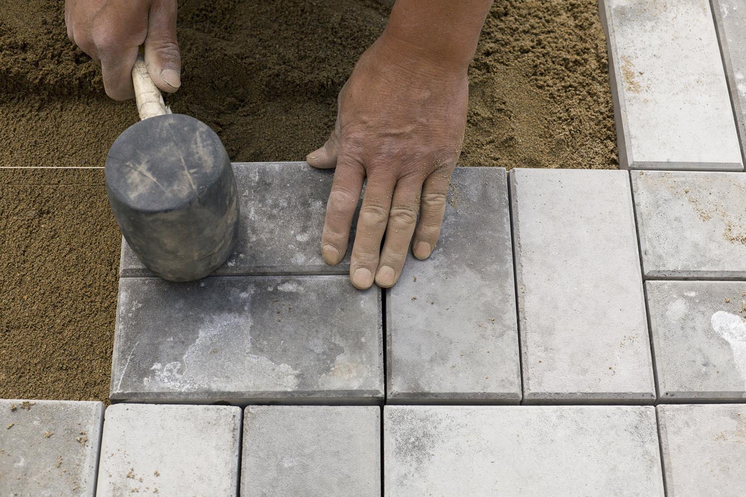 Man laying paving stones